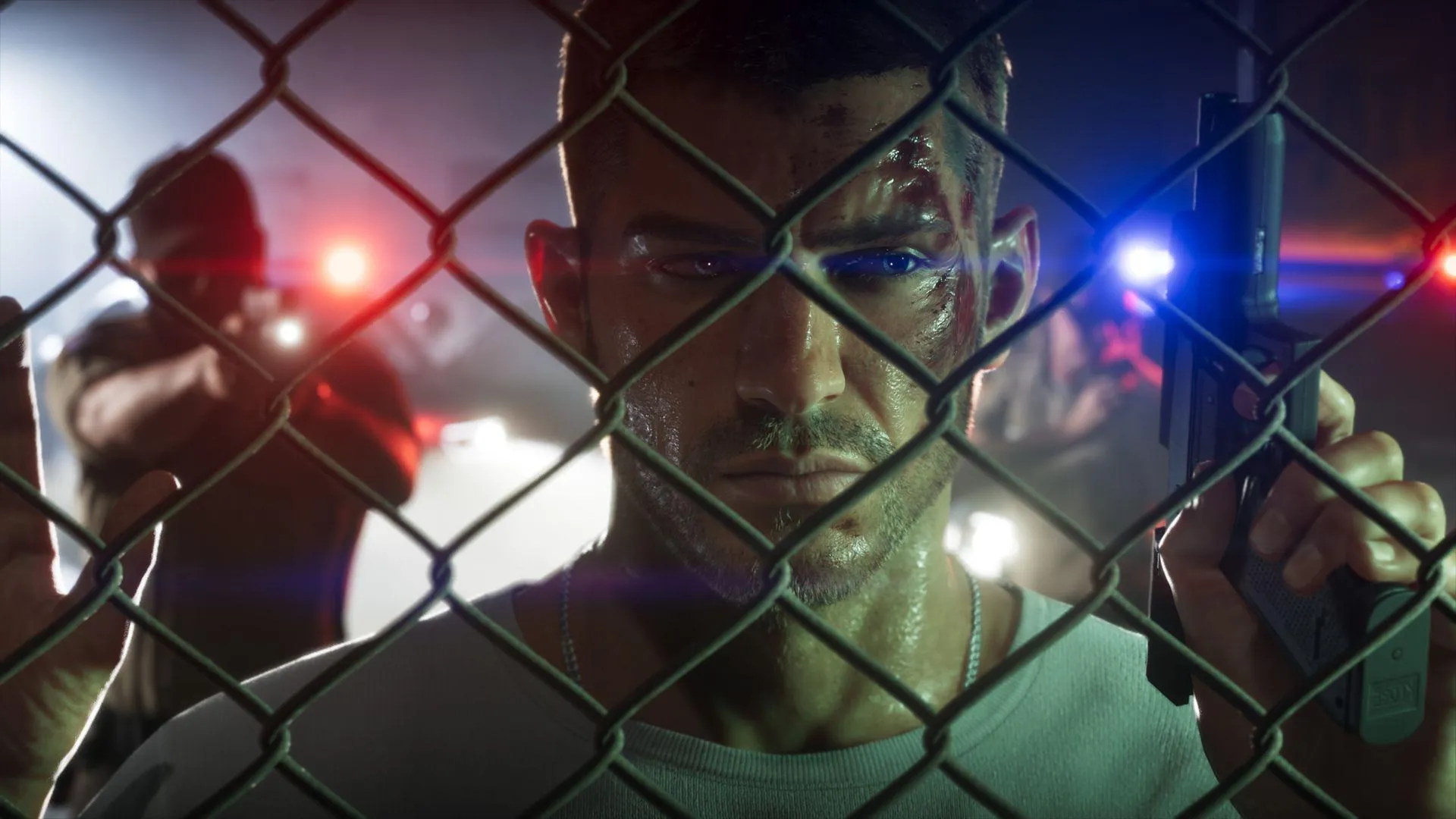 Jason Duval at a chain-link fence with police lights behind him