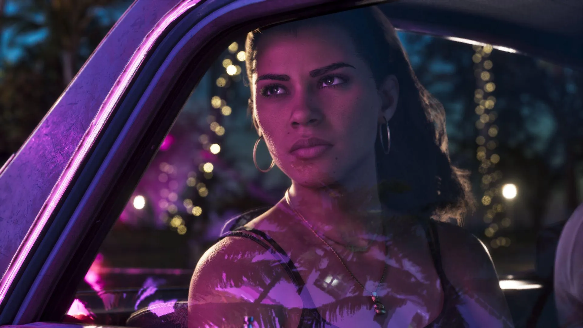 Lucia Caminos in a car under pink and blue neon light